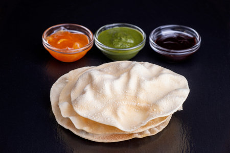 papadam with various indian sauces