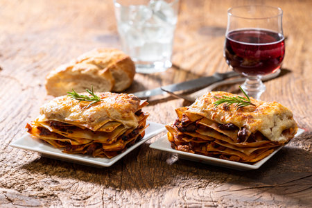 Two portions of lasagne on woodの写真素材