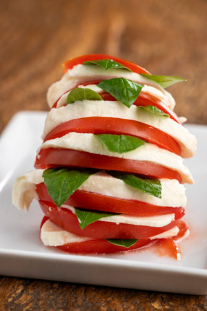 Caprese salad with mozzarella cheese, tomatoes and basilの写真素材