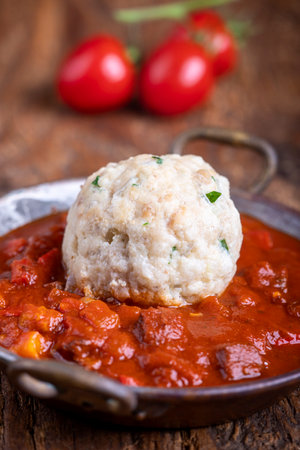 Hungarian goulash with dumpling on woodの写真素材