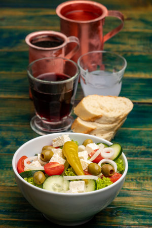 Greek salad on green woodの写真素材