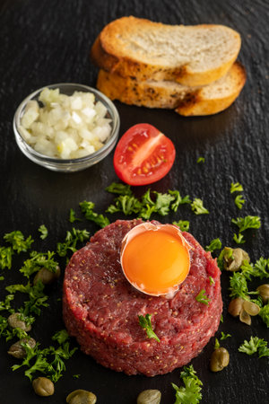 Steak tartare on black slateの写真素材
