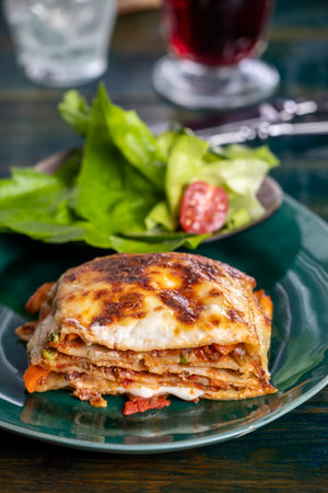 Italian lasagne on a green plateの写真素材