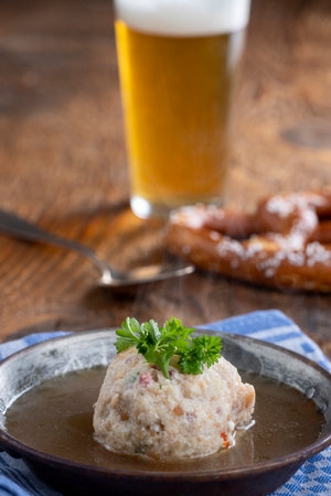 Austrian ham dumpling soup on woodの写真素材