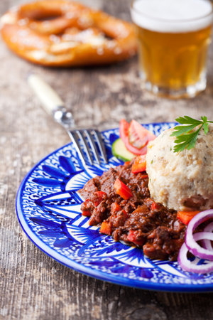 goulash with dumpling on a blue plateの写真素材