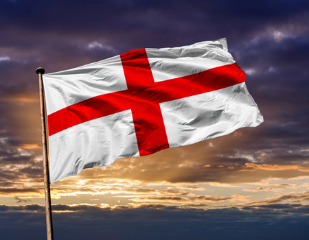 St George's Cross Flag of England Waving Proudly Against a Cloudy Sunset Skyの素材