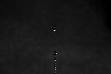 Den Helder, the Netherlands. January 2022. Splashing drop against gray background. High quality photoの写真素材