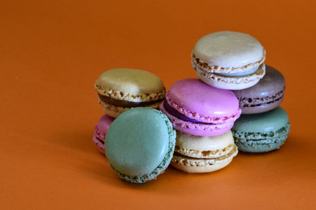Den Helder, the Netherlands. January 2022. A stack of macarons on an orange background. High quality...