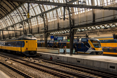 Amsterdam, Netherlands, march 2022. Dutch train in the landscape and in the central station. High...