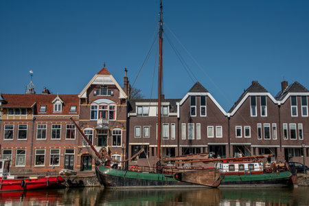 Hoorn, Netherlands, March 2022. The harbor of Hoorn with the old boats and historic facades. High quality photoのeditorial素材