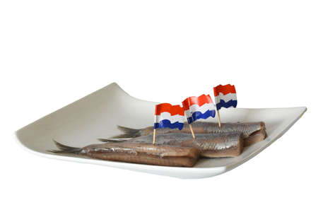 Den Helder, Netherlands. June 2022. Fresh raw herring on a white plate. Isolated. selective focus. High quality photoの写真素材
