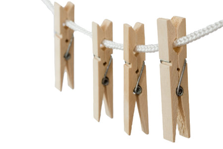 Wooden clothes pegs on a white background, isolated. Selective focus. High quality photo