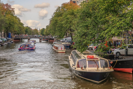 Amsterdam, Netherlands. October 2022. The canal boats on the narrow canals of Amsterdam. High quality photoのeditorial素材