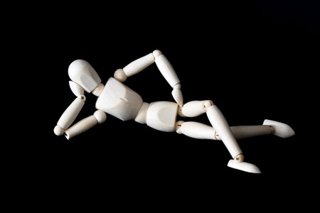Den Helder, Netherlands. January 2023. Wooden dummies in different poses on a black background. High...