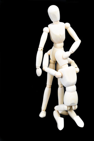 Den Helder, Netherlands. January 2023. Wooden dummies in a sex pose, isolated on a black background. High quality photoの写真素材