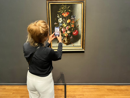Amsterdam, Netherlands. August 6, 2023. A visitor taking pictures of famous paintings. . High quality photoのeditorial素材