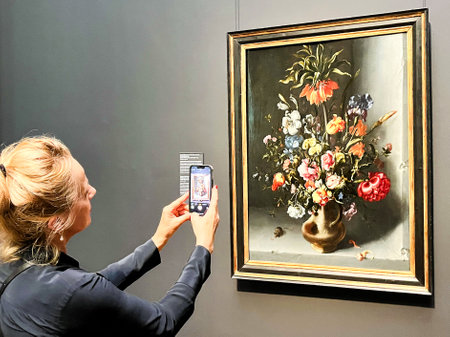 Amsterdam, Netherlands. August 6, 2023. A visitor taking pictures of famous paintings. . High quality photoのeditorial素材