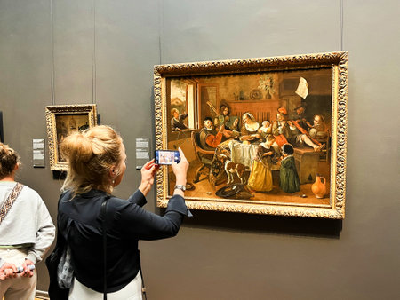 Amsterdam, Netherlands. August 6, 2023. A visitor taking pictures of famous paintings. . High quality photoのeditorial素材