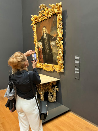 Amsterdam, Netherlands. August 6, 2023. A visitor taking pictures of famous paintings. . High quality photoのeditorial素材