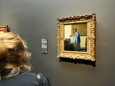 Amsterdam, Netherlands. August 6, 2023. A woman takes a picture of world-famous painting at the Rijksmuseum Amsterdam. High quality photoのeditorial素材