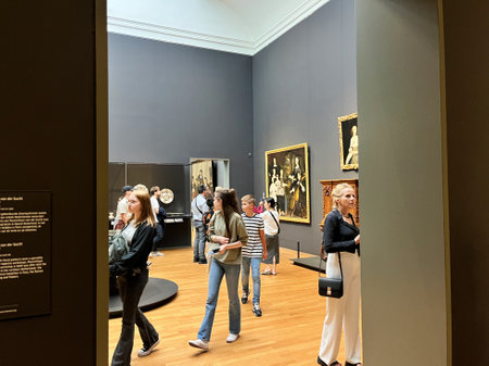 Amsterdam, Netherlands. August 6, 2023. Visitors admire one of the many paintings at the Rijksmuseum in Amsterdam. High quality photoのeditorial素材