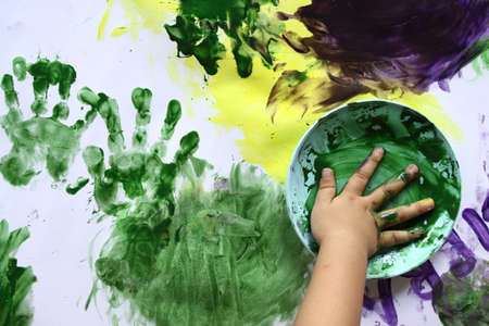 toddler hands playing watercolorの写真素材