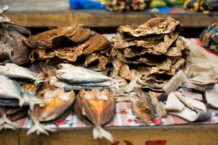 Dried fish full of flies is sold in a local market in Madagascarの写真素材