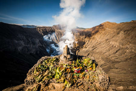 Hindu people give offerings to their god Ganesh on the crater of Bromo volcanoの写真素材