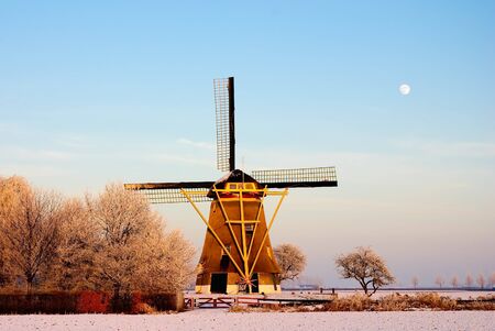 A well maintained windmill in the snow. A few minutes before sunset.の写真素材