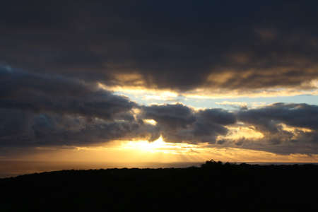 Rays bursting though clouds after rainの写真素材