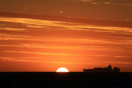 Cargo ship at sunsetの写真素材