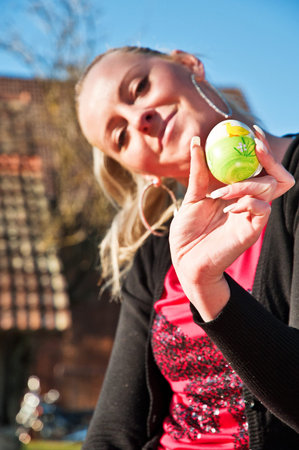 Woman holding a painted Easter egg