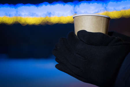 paper cup of coffee in your handsの写真素材