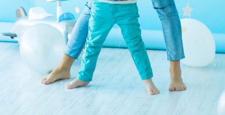 soft focus of the foot of the son and mother on the light floor are widely arranged, the concept of...