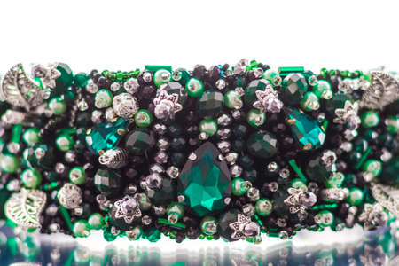 Colorful gems. stones of emerald color on the rim for the headの写真素材