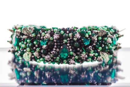 Colorful gems. stones of emerald color on the rim for the headの写真素材
