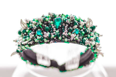 Colorful gems. stones of emerald color on the rim for the headの写真素材