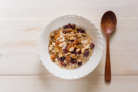 topview of bowl of muesli of white wooden backgraundの写真素材