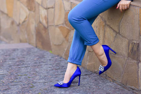 slender legs in blue breeches and heels on a hairpinの写真素材