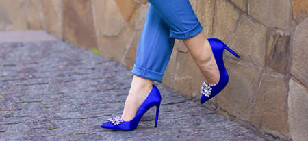 slender legs in blue breeches and heels on a hairpinの写真素材