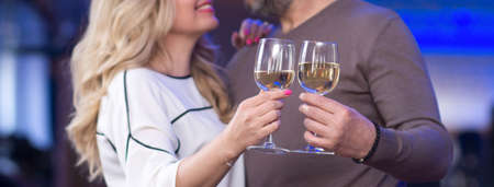 Close up two hands toasting champagne glassesの写真素材