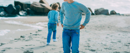 Two young boys having fun on beach, happy best friends playing , sea, ocean