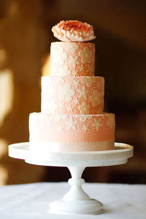 wedding cake decorated with white flowers on the restaurant backgroundの写真素材