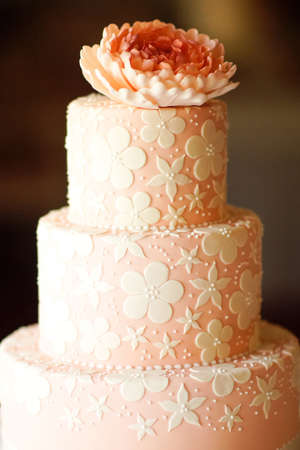 wedding cake decorated with white flowers on the restaurant backgroundの写真素材