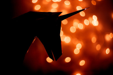 Fantastic photo of the silhouette of a unicorn on the background of a bokeh from the lights of a...
