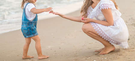 Happy mother and kid on the beachの写真素材