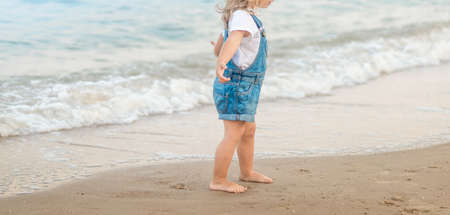 Girl is walking on the beach at sea. summerの写真素材