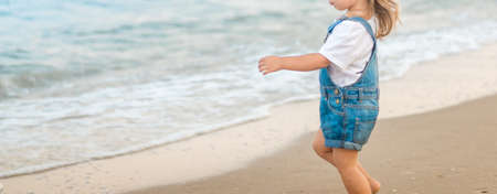 Girl is walking on the beach at sea. summerの写真素材