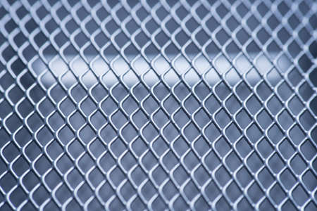 macro gray metallic grid with lighting effects. background monochrome. background metal. place for textの写真素材