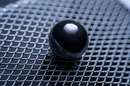macro photo. metal ball on the background of iron grating, side viewの写真素材